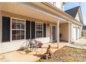 Inviting front porch with seating area, charming decor, and a welcoming entrance at 5023 Wicklow Dr, Gastonia, NC 28054