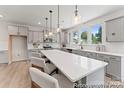 Well-lit kitchen with light gray cabinets, a large island with seating, and modern pendant lighting at 5606-B Galloway Dr # 97P, Stanfield, NC 28163