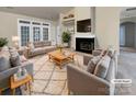 Bright living room with a fireplace, plush rug, and stylish furniture creates a cozy and inviting space at 6310 Lily Pad Ct, Charlotte, NC 28262