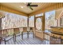 Cozy screened-in back porch featuring outdoor seating and a grill with wooded views at 809 Liberty Rd, Gold Hill, NC 28071
