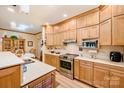 Bright kitchen with wood cabinets, stainless steel appliances, and view into the dining area at 809 Liberty Rd, Gold Hill, NC 28071