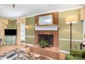 Cozy brick fireplace with a decorative mirror above, creating a warm and inviting focal point in the living room at 907 Paul Revere Ln, Gastonia, NC 28056