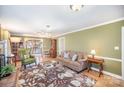 Inviting living room featuring hardwood floors, a floral rug, and a comfortable seating area with a glass coffee table at 907 Paul Revere Ln, Gastonia, NC 28056