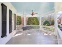 Inviting porch features a swing, ceiling fan, and painted ceiling at 9128 Summer Club Rd, Charlotte, NC 28277