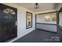 Cozy front porch showcasing the entrance, lighting, and gray railings at 922 Grace Ave, Kannapolis, NC 28083