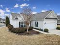 Well-maintained single-story house featuring manicured landscaping, windows, and a two-car garage at 1001 Mesa Verde Dr, Fort Mill, SC 29707