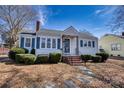 Charming single-story home with blue shutters, manicured bushes, brick chimney, and inviting front entrance at 111 Courtland St, Chester, SC 29706