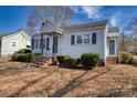 Charming single-story home with blue shutters, manicured bushes, brick chimney, and inviting front entrance at 111 Courtland St, Chester, SC 29706