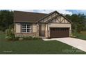 Charming single-Gathering home with stone accents, tan siding, a two-car garage, and manicured lawn at 2656 Tillman St, Monroe, NC 28112