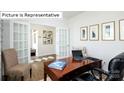 Well-lit home office featuring a desk, laptop, comfortable seating, and natural light at 451 Zender Ln, Monroe, NC 28112