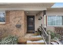 Inviting front porch with brick accents, a bench, and charming details, creating a welcoming entrance at 5311 Agner Dr, Salisbury, NC 28146