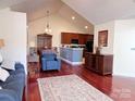 Open concept living area with a vaulted ceiling, seamlessly connecting to the kitchen and dining at 5518 Prosperity View Dr, Charlotte, NC 28269