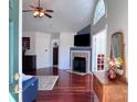 Open living room with hardwood floors, a fireplace, and high ceilings for comfortable living at 5518 Prosperity View Dr, Charlotte, NC 28269