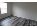 Bright bedroom features wood-look flooring and a window with natural light at 586 30Th Avenue Ne Cir, Hickory, NC 28601