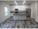 Modern kitchen with stainless steel appliances, granite countertops, and a large center island at 586 30Th Avenue Ne Cir, Hickory, NC 28601