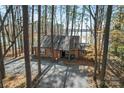 Charming brick home nestled among trees, offering privacy and a serene setting at 693 Emerald Shores Rd, Mount Gilead, NC 27306