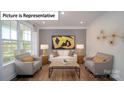 Cozy living room featuring hardwood floors, modern furniture, neutral paint, and large windows at 7027 Sylvan Retreat Dr, Denver, NC 28037