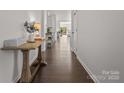 Bright hallway with hardwood floors, leading to various rooms, creating an open feel at 7127 Chrysanthemum Rd, Lancaster, SC 29720