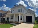 Inviting two-story home showcasing a charming front porch with classic white columns at 7459 Fighting Creek Rd # 33, Sherrills Ford, NC 28673