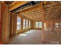 Unfinished living room area featuring bare stud walls with framing for multiple windows at 7459 Fighting Creek Rd # 33, Sherrills Ford, NC 28673