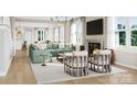 Bright living room with a fireplace, large windows, light hardwood floors and comfortable seating at 7459 Fighting Creek Rd # 33, Sherrills Ford, NC 28673