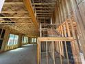 Unfinished interior framing with a staircase leading to an upper level with exposed rafters at 7459 Fighting Creek Rd # 33, Sherrills Ford, NC 28673
