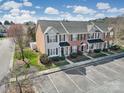 Attractive townhomes featuring brick and siding exteriors, complemented by lush landscaping and parking at 8004 Sapwood Ct, Matthews, NC 28104
