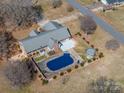 Aerial view of private backyard featuring a covered pool, a patio, and mature trees at 102 3Rd Se Ave, Catawba, NC 28609