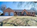 Charming brick home featuring an attached two-car garage and manicured front lawn at 102 3Rd Se Ave, Catawba, NC 28609