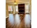 Bright living room featuring a brick fireplace, hardwood floors, and natural light at 1146 Crestmont Se Dr, Concord, NC 28025