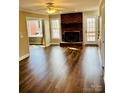 Cozy living room featuring a brick fireplace, hardwood floors, and access to the deck at 1146 Crestmont Se Dr, Concord, NC 28025