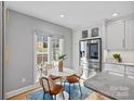 Bright breakfast nook featuring a round table with chairs, stainless steel appliances, and natural light at 1301 Charter Pl, Charlotte, NC 28211