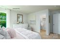 Well-lit bedroom with a large window, dresser, and walk-in closet at 1348 Secrest Commons Dr, Monroe, NC 28112