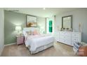 Cozy bedroom featuring neutral tones, a comfortable bed, and a spacious dresser at 1348 Secrest Commons Dr, Monroe, NC 28112