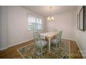 Cozy dining room featuring a charming chandelier, a large window, and an elegant rug at 1348 Secrest Commons Dr, Monroe, NC 28112