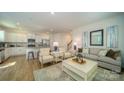Bright and airy living room with neutral decor, hardwood floors, and ample seating for entertaining guests at 1348 Secrest Commons Dr, Monroe, NC 28112