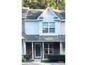 Inviting townhouse exterior featuring a covered entryway, brick accents, and tidy landscaping at 140 Marakery Rd # C, Mooresville, NC 28115