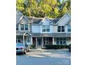 Charming townhouse exterior with brick accents, well-kept landscaping, and inviting entrance at 140 Marakery Rd # C, Mooresville, NC 28115