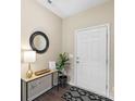 Entryway with wood-look floors, a modern console table with decor, and a geometric patterned rug at 147 Stanfield Farm Ln, Stanfield, NC 28163