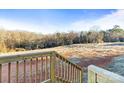 Backyard view looking from the porch over the brown grass and bare trees in the distance at 1536 Washington Ln, Catawba, NC 28609