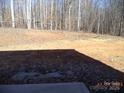 View of the property's spacious, wooded backyard at 184 Oak Creek Rd, Statesville, NC 28625