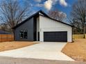 New construction home with a modern design, two-car garage and black and white color scheme at 205 Skyline Cir, Salisbury, NC 28146