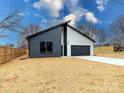 New construction home with a modern design, two-car garage and black and white color scheme at 205 Skyline Cir, Salisbury, NC 28146