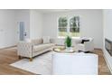 Bright living room with modern decor, a tufted sofa and large windows providing natural light at 205 Skyline Cir, Salisbury, NC 28146