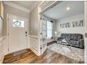 Welcoming living room with hardwood floors, white trim, and comfortable gray couches at 2050 Saddlebred Dr, Iron Station, NC 28080