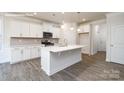 Modern kitchen with white cabinets, stainless appliances, an island and hard surface countertops at 2058 Skyhawk Dr, Lake Wylie, SC 29745