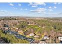 Aerial view of the property showcasing the home's location surrounded by lush trees at 214 Harbor Landing Dr, Mooresville, NC 28117