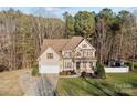 Attractive home with a two-car garage, well-kept lawn, and beautiful landscaping at 214 Harbor Landing Dr, Mooresville, NC 28117