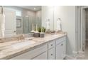 Bathroom with double sinks, granite countertops, decorative mirrors, and tile flooring at 2150 Millennium Dr # 094, Lancaster, SC 29720