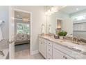Bright bathroom with double vanity, granite countertop, large mirror, and a view into the bedroom at 2150 Millennium Dr # 094, Lancaster, SC 29720